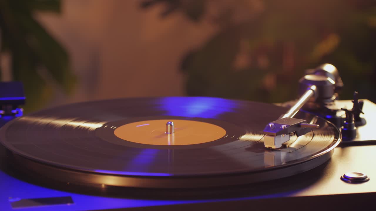 Retro Vinyl record player playing music, close-up macro shot of vintage LP disc old phonograph spinning. Retro music player.