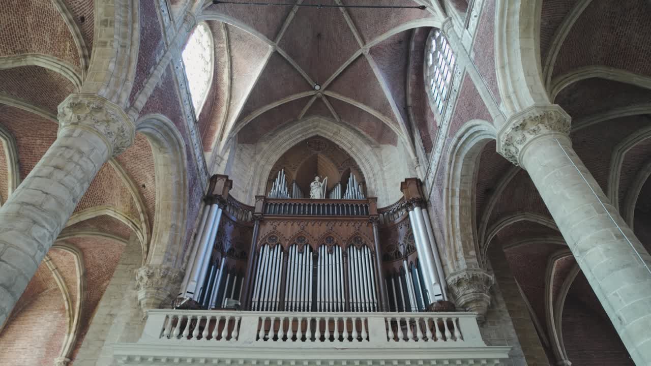 Majestic pipe organ with gothic arches inside Saint Michael's Church in Ghent Belgium