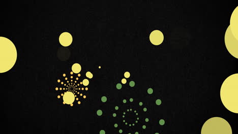 animation of green and orange firework explosions and bokeh yellow light spots on black background