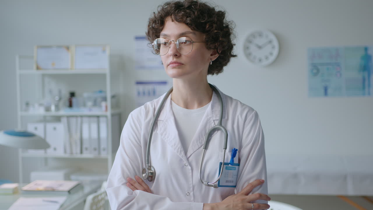 Portrait of Young Female Doctor Posing with Arms Crossed in Clinic
