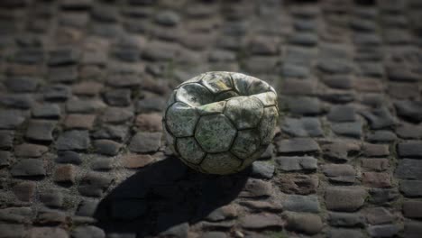 Old-soccer-ball-in-the-pavement-yard