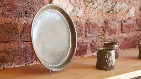 handmade ceramic plate and mugs on a shelf