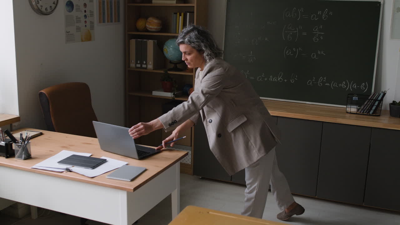 Teacher giving an online class in a classroom