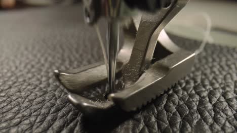 close-up of a sewing machine stitching leather