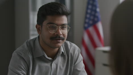 indian applicant attending visa interview with immigration officer at us embassy
