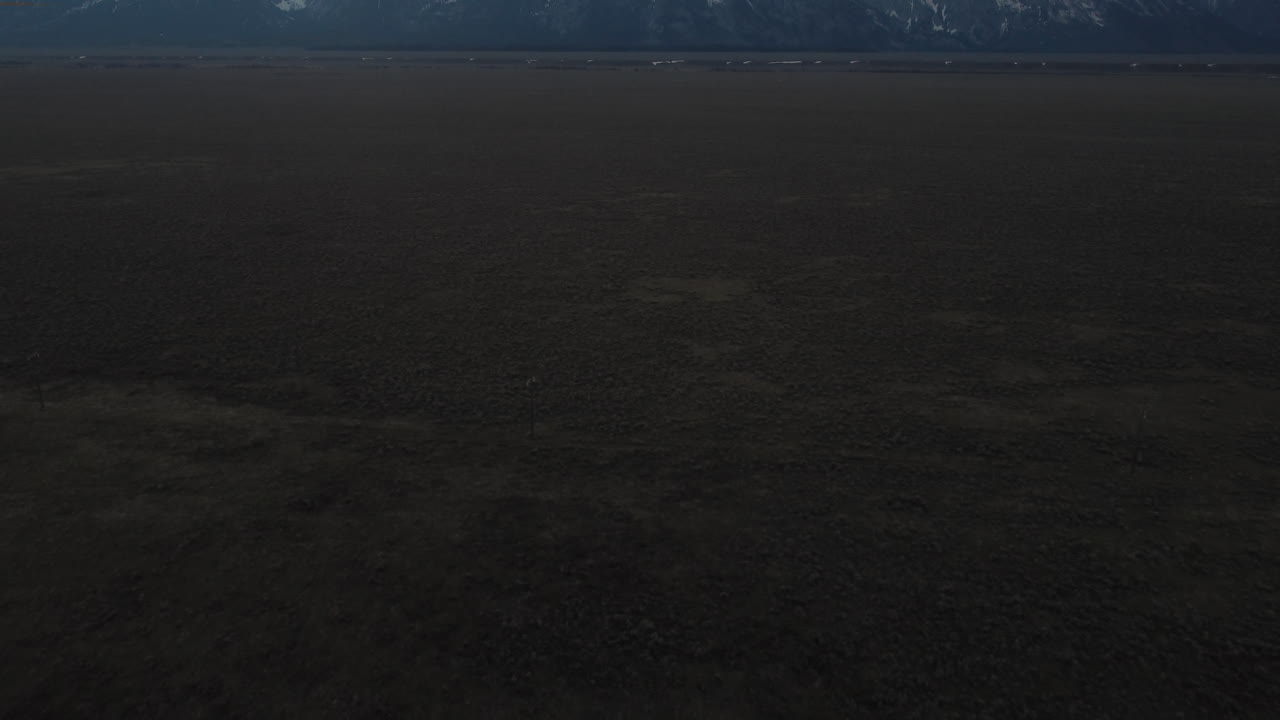 Aerial View of Vast Plains and Distant Mountains