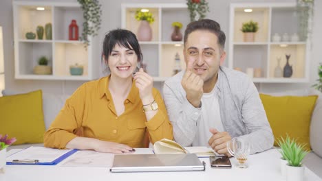 couple making money sign.