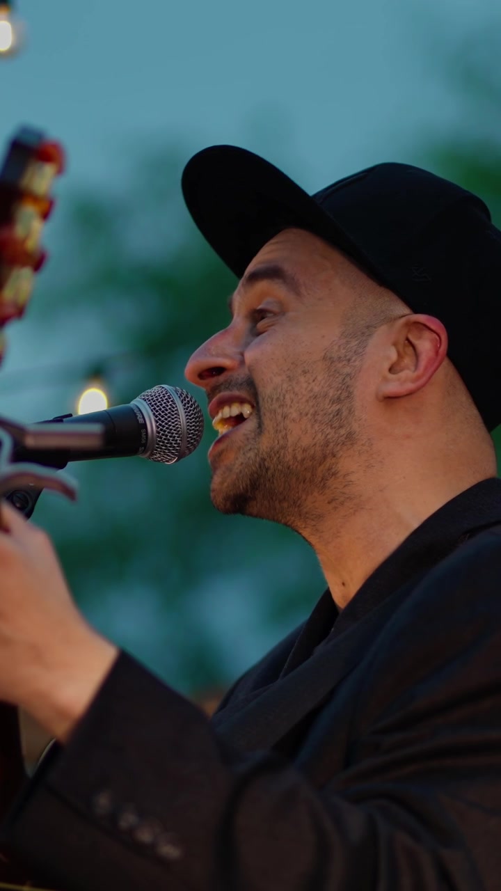 Close-up of Man Singing and Playing Acoustic Guitar Live