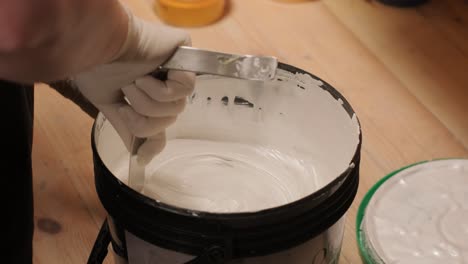 a worker kneads the paint for painting the walls