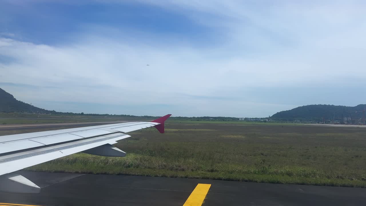 Passenger views plane wing during morning runway taxiing, calm and serene