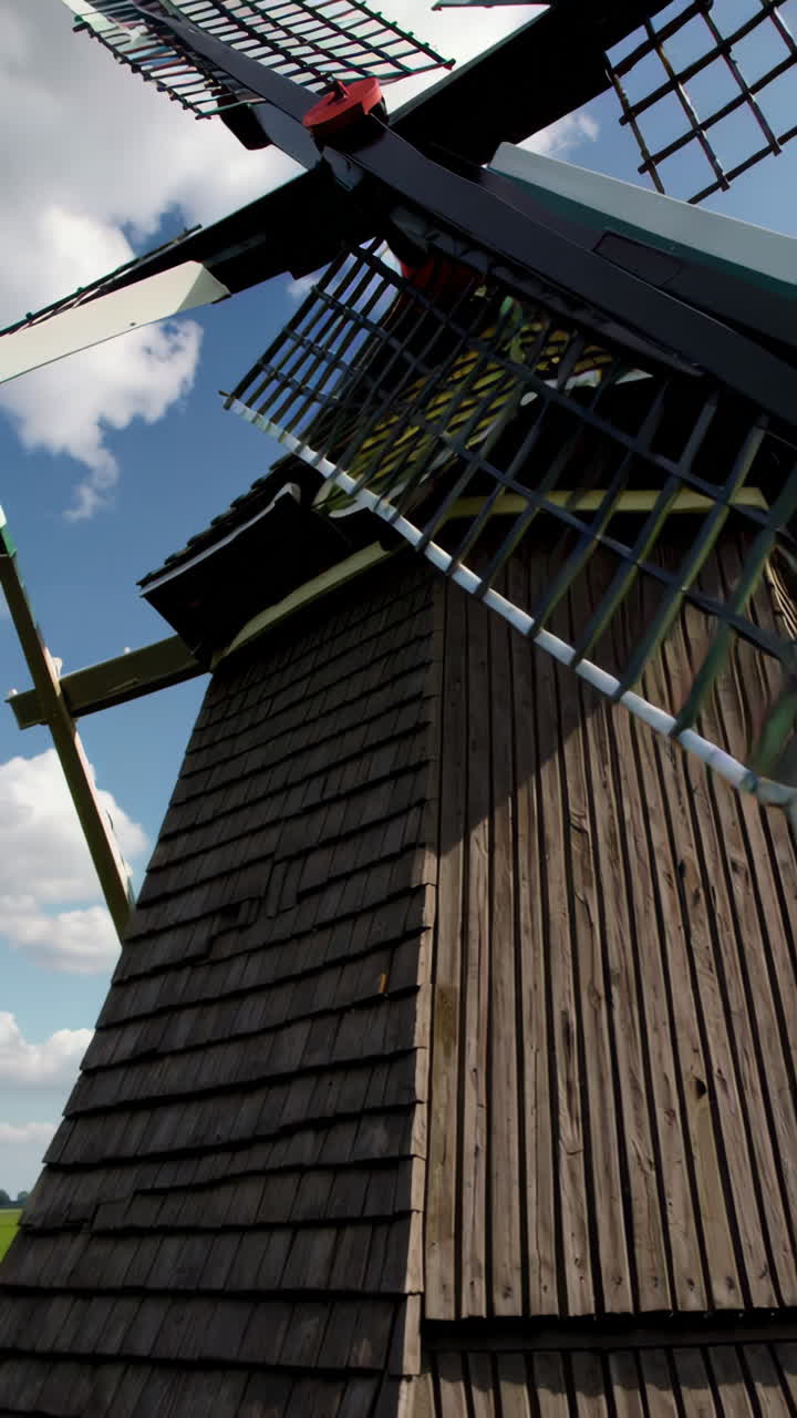 Dutch Windmills in a Green Field