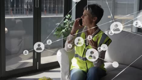 Animation-of-network-of-digital-icons-over-woman-engineer-using-smartphone