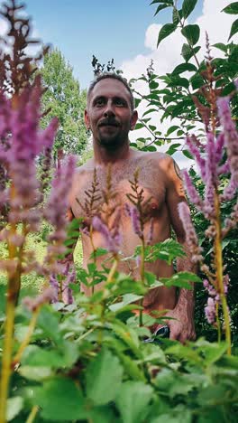 man in a garden with flowers