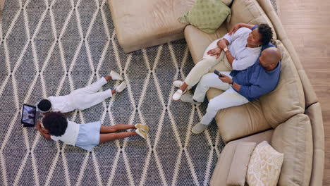 top view, kids and tablet on floor with parents