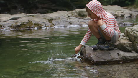 child playing in a creek