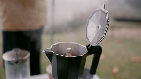 hands, boiling coffee and kettle for camping