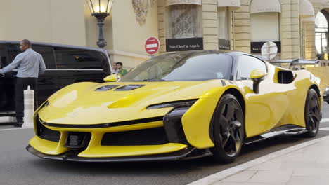 yellow ferrari supercar in front of van cleef & arpels