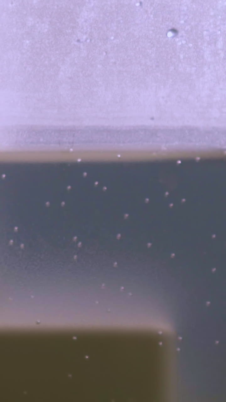 CU: plastic transparent side of modern air ionizer with small bubbles used to humidify home atmosphere extreme close view