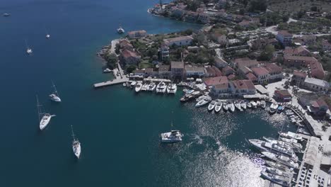 aerial view of a picturesque coastal village and marina with yachts