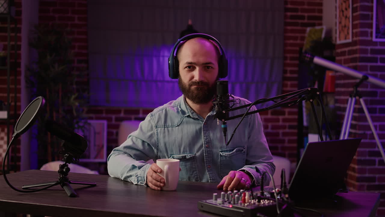 Portrait of online radio host recording podcast for entertainment show using professional audio equipment