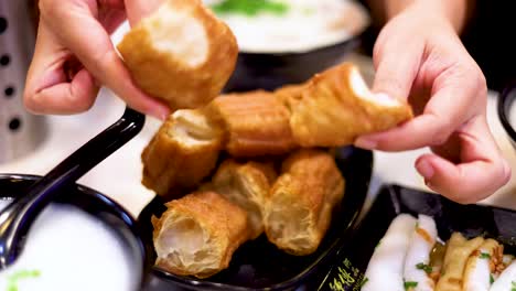 hands arranging fried dough on a plate