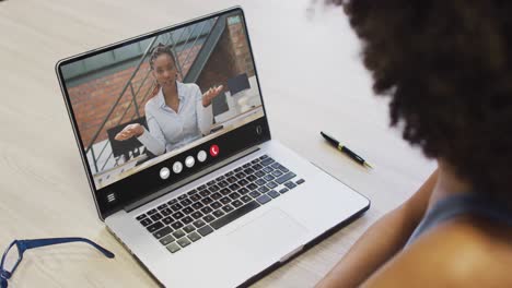 Animation-of-african-american-woman-having-video-call-on-laptop