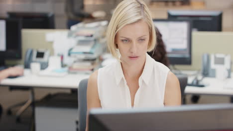 powerful businesswoman executive working at computer using smart phone connected to global data in busy corporate office