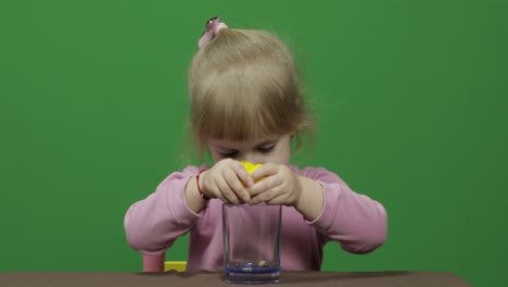 Beautiful-young-girl-squeezes-lemon-juice-and-drinks-it-with-a-grimace-on-face