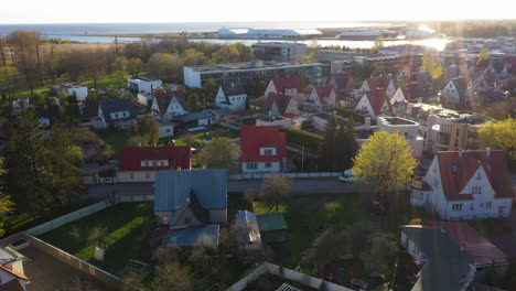 Residential-Area-with-private-homes-during-golden-hour-sunlight,-view-from-above