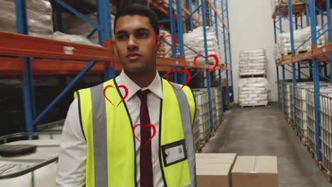 Animation-of-falling-hearts-over-biracial-warehouse-worker