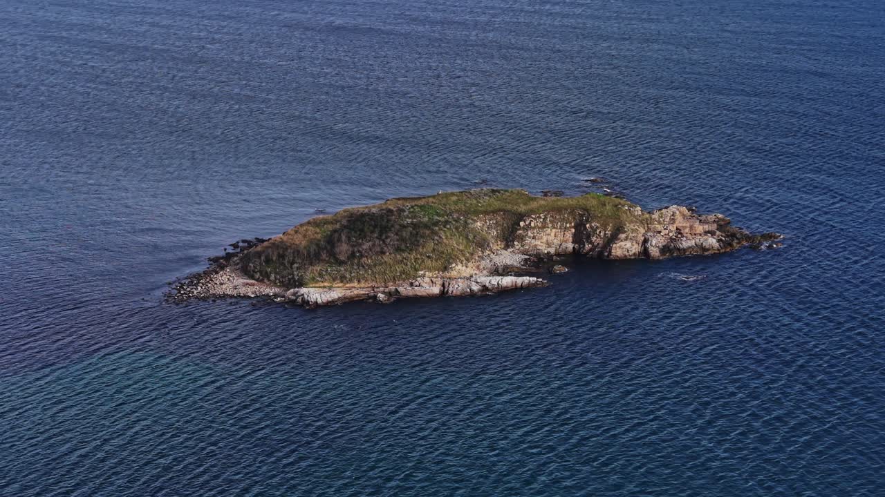 Aerial view of a small island surrounded by calm blue waters