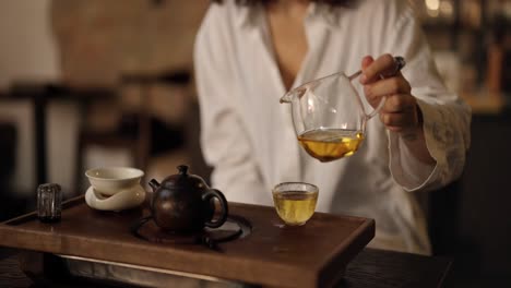 woman pouring tea during a traditional tea ceremony