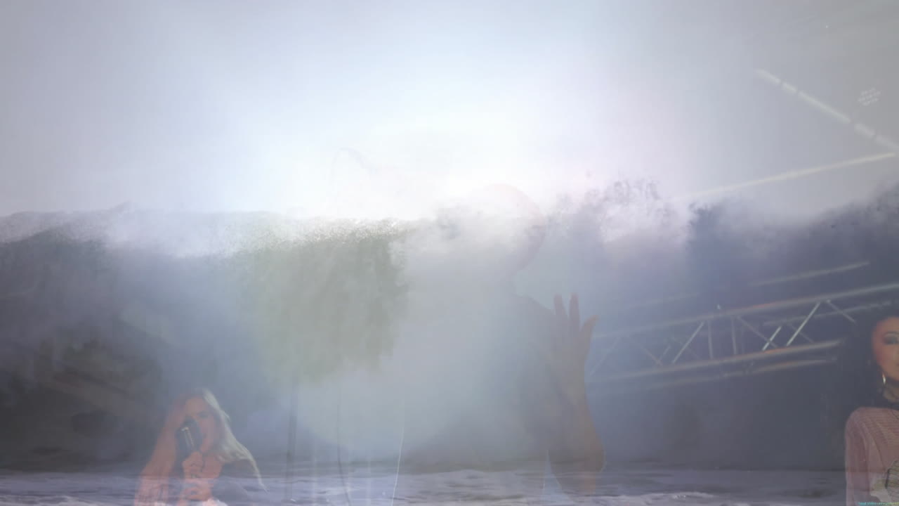 Three singers performing on entertainment stage, casting purple and white lights through fog haze