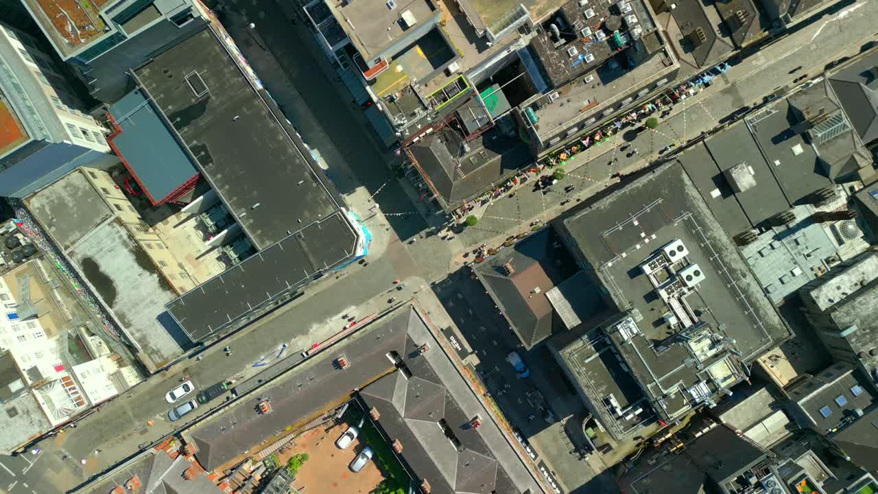 Wide, descending overhead aerial of the Temple Bar area in Dublin, Ireland on a bright and sunny day. Filmed in 4K, 60FPS and with Rec709 color.