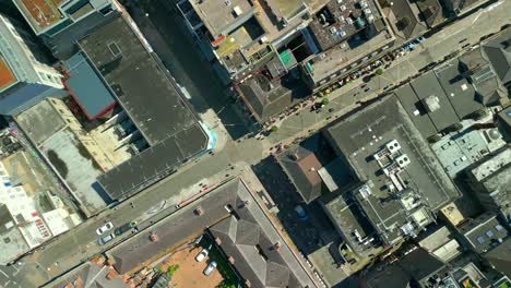 wide, descending overhead aerial of the temple bar area in dublin, ireland on a bright and sunny day. filmed in 4k, 60fps and with rec709 color.
