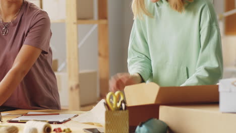 two women collaborating in a shipping/packaging business