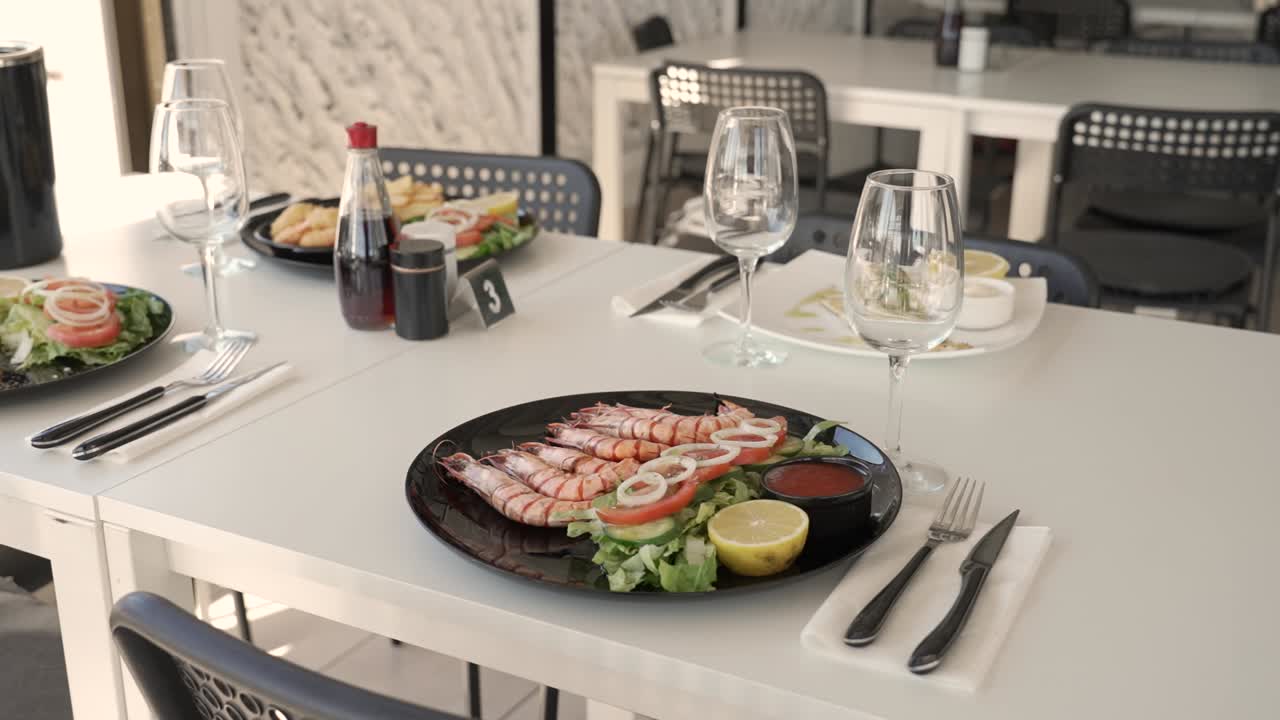 Delicious grilled shrimp served with fresh greens in a vibrant dining space during a sunny afternoon in a coastal city