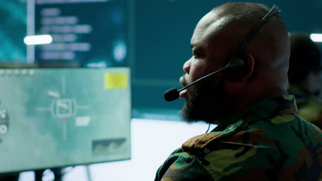 government intelligence officer in high tech command post oversee satellite data