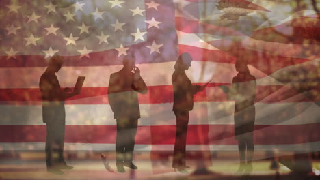 animation of autumn leaves falling over flag of usa and people silhouettes