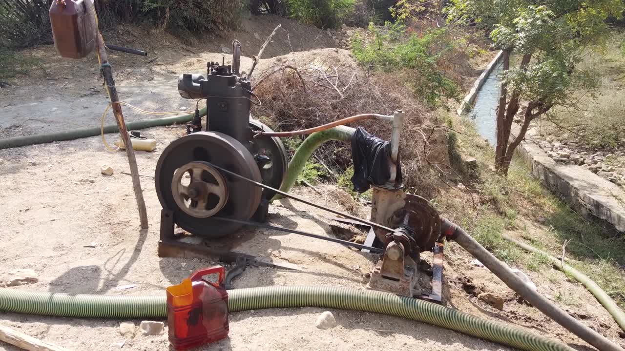 Water pump engine used in agriculture is pumping water to farms  from water canal in villages