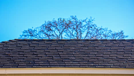 ice and snow melting off a roof as the sun rises - time lapse