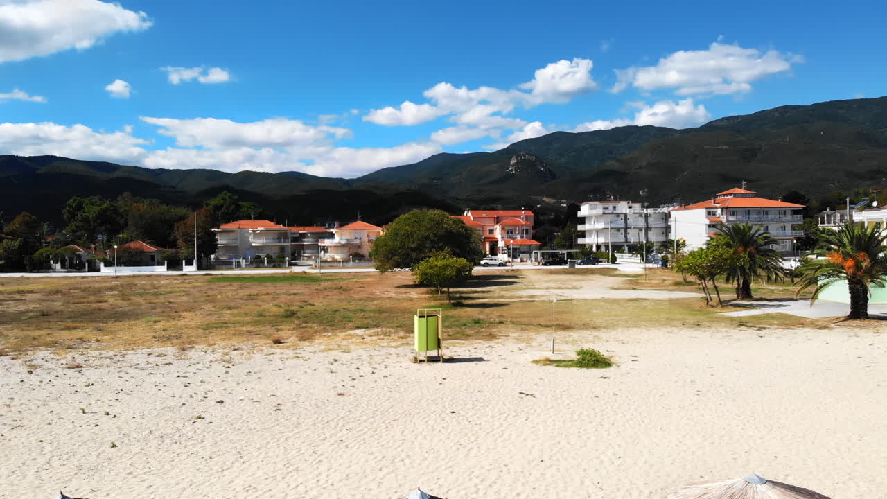 Beach with umbrellas and sunbeds. Foam. Top drone view