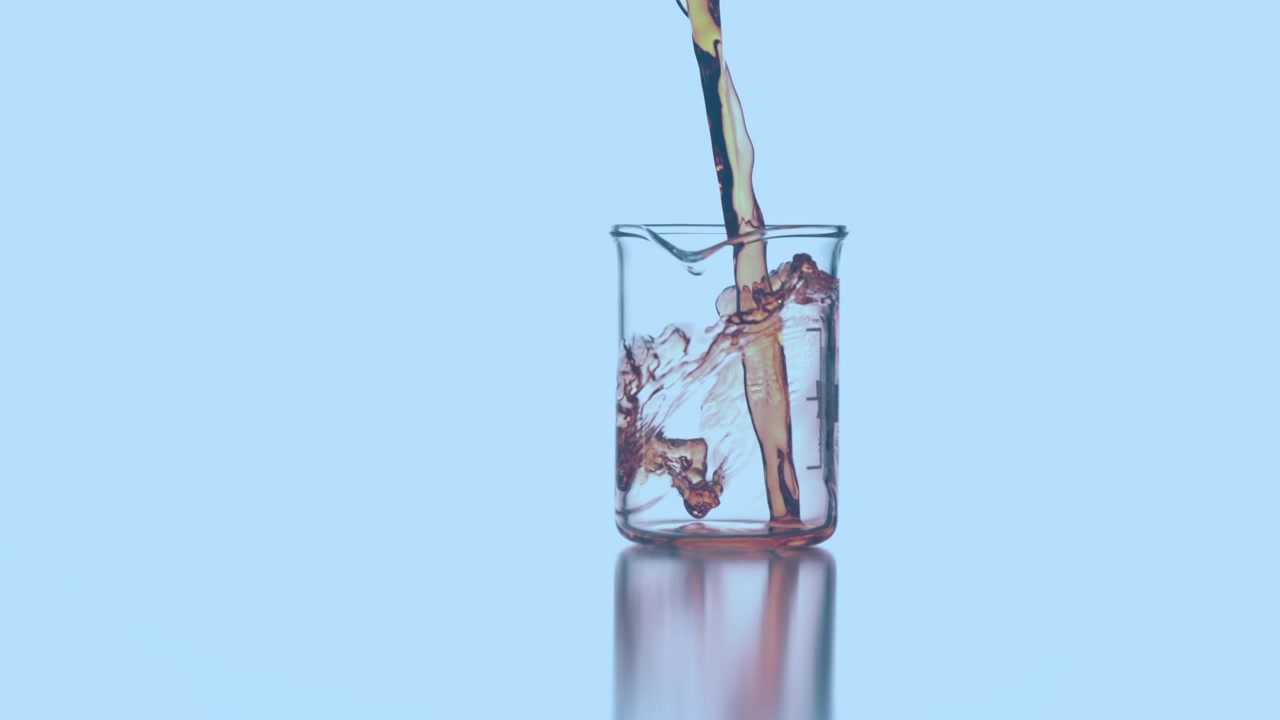 Animation of red dots floating over liquid pouring into lab glass