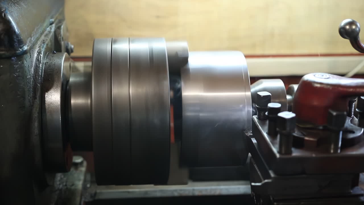 Craftsman or metalworker industrial experienced operator technician worker Skilled machinist working intently on a large industry in metal factory workshop with Large Machines