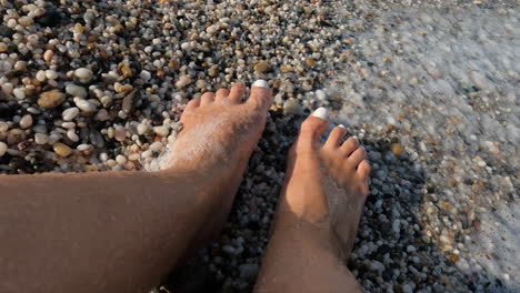 slow motion - womans feet in sea foam