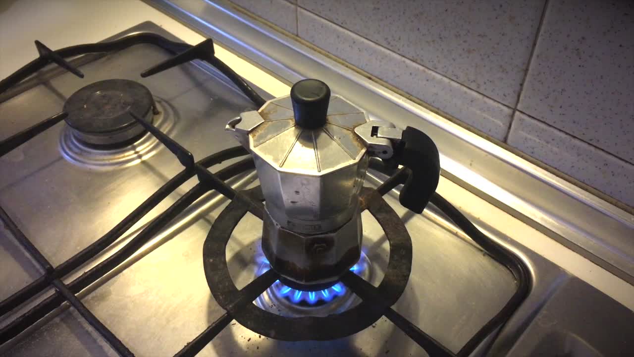Closing Lid on Moka Pot Over Fire on stovetop