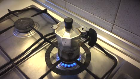 closing lid on moka pot over fire on stovetop