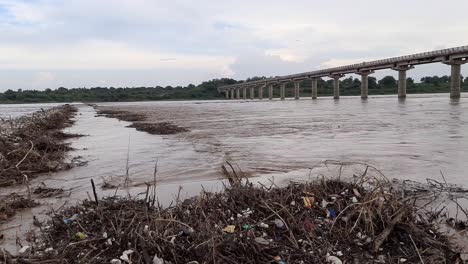 Waste-garbage-and-driftwood-on-the-dirty-water-surface