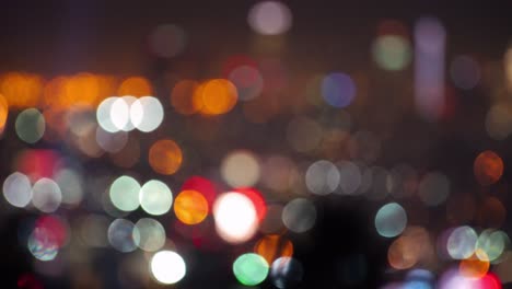 LA: Downtown LA skyscrapers focus pull bokeh to reveal skyline, with searchlights in the foreground, shot from Hollywood Hills - Los Angeles California, USA