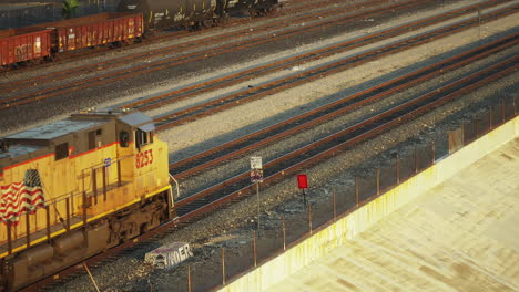 Aerial-shot-of-train-tracks-and-train-passing-in-Los-Angeles,-CA-in-the-6th-st-bridge